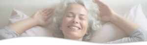 Middle aged woman smiling after acupuncture session for headaches and migraines.