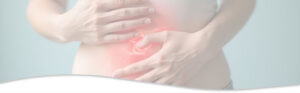 Young woman with digestive issues holding her belly.